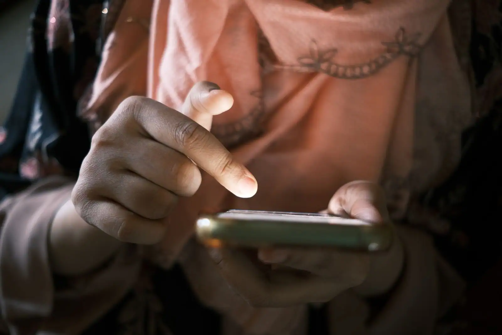 Gros plan sur les mains d'une personne utilisant une application sur l'écran de son smartphone