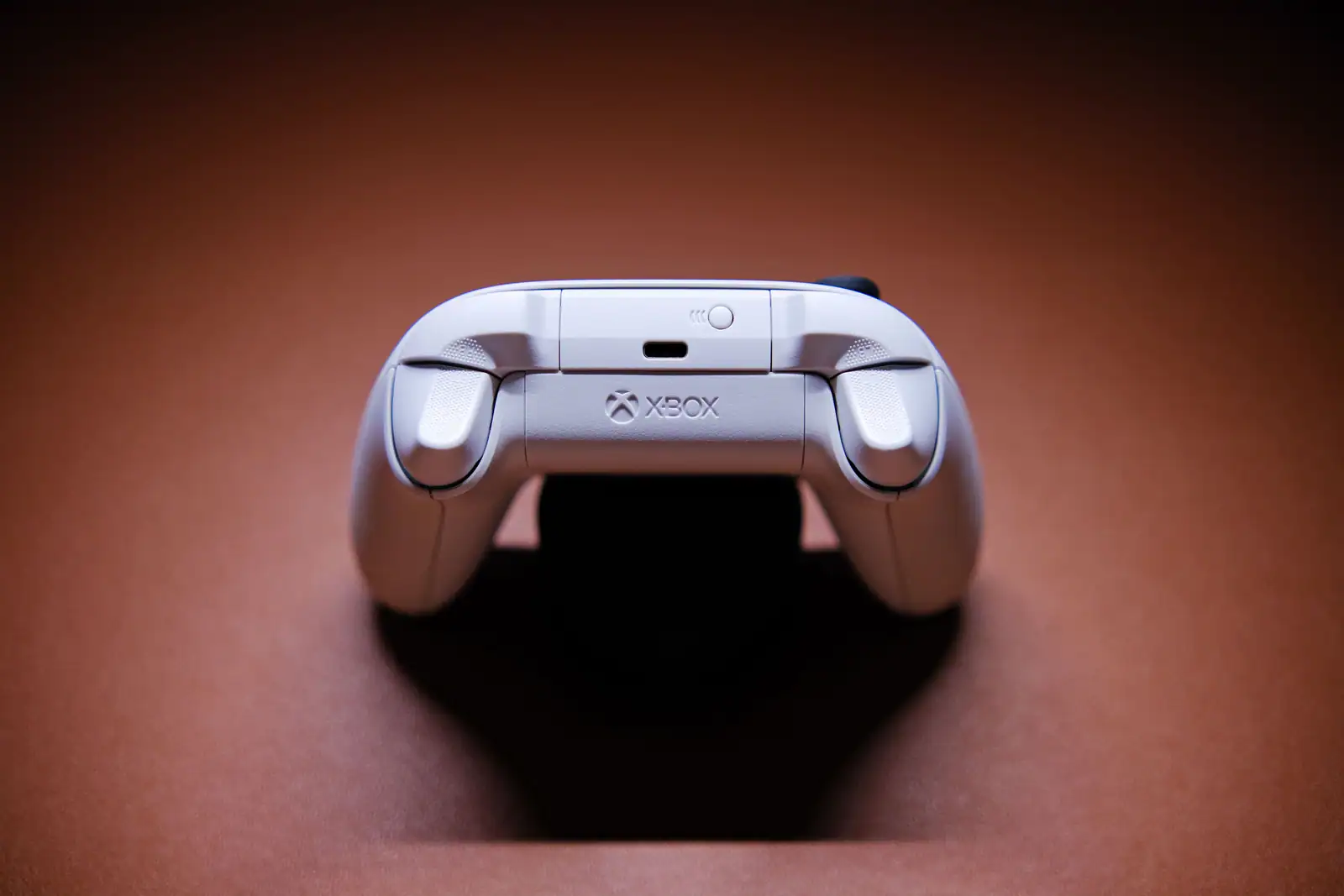 Manette Xbox blanche avec le logo Xbox visible, illustrant le jeu multi-appareils.
